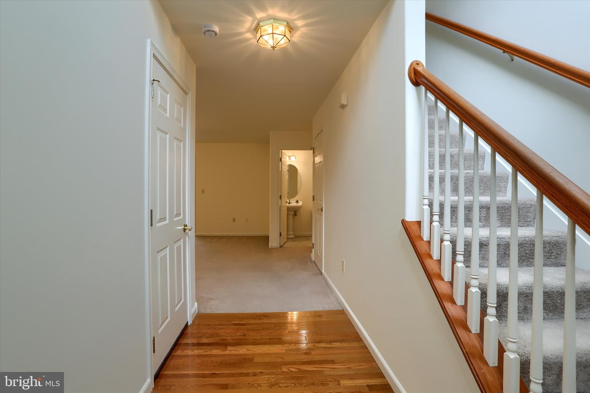 221 West Locust Street Enola, PA 17025 - Photo 5 of 46 a view of a hallway with wooden floor and staircase