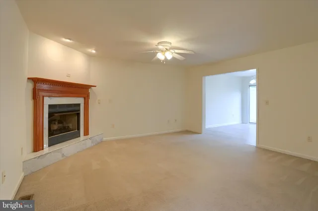 a view of empty room with a fireplace