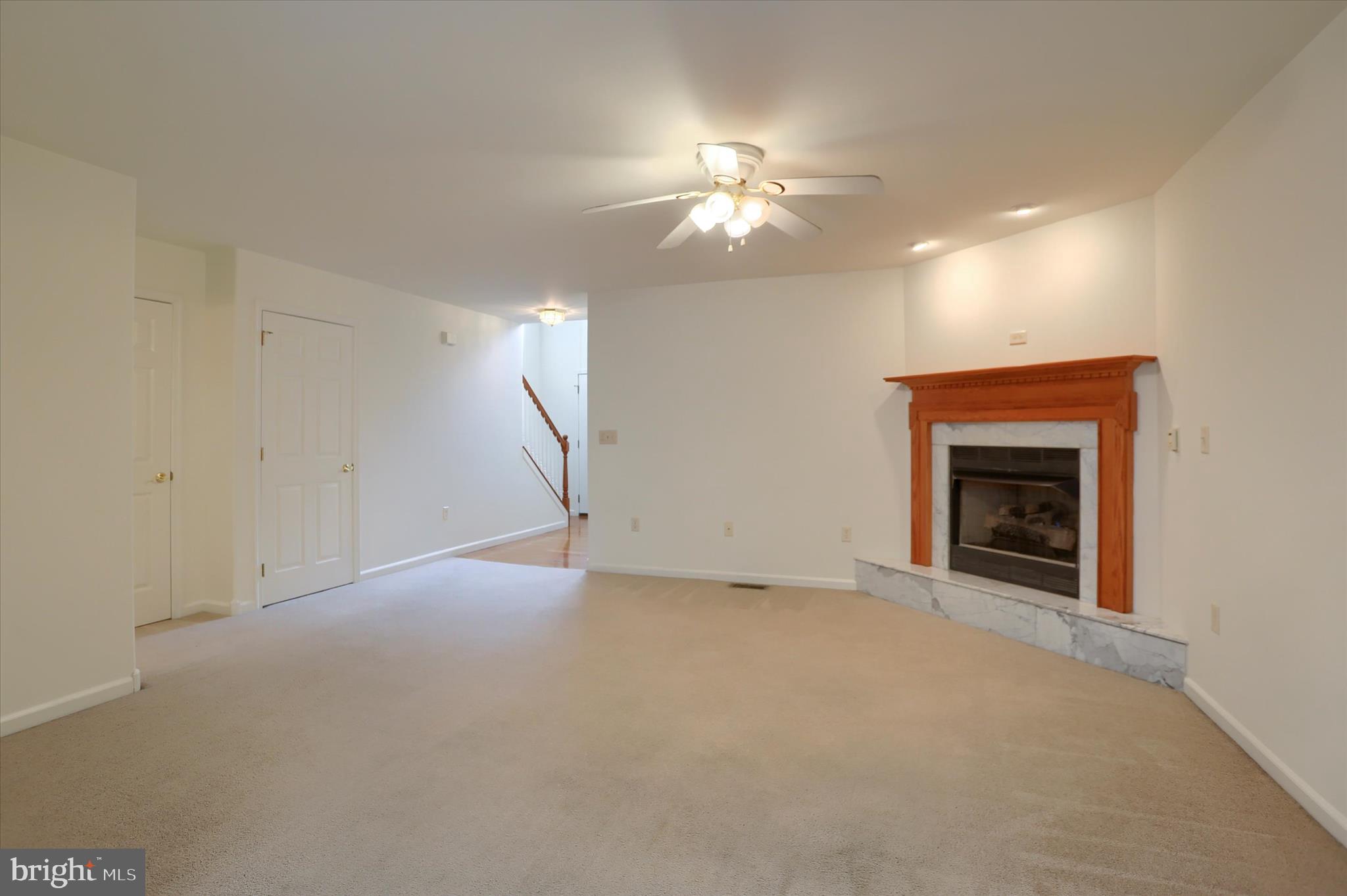 221 West Locust Street Enola, PA 17025 - Photo 9 of 46 a view of an empty room with chandelier fan and fire place