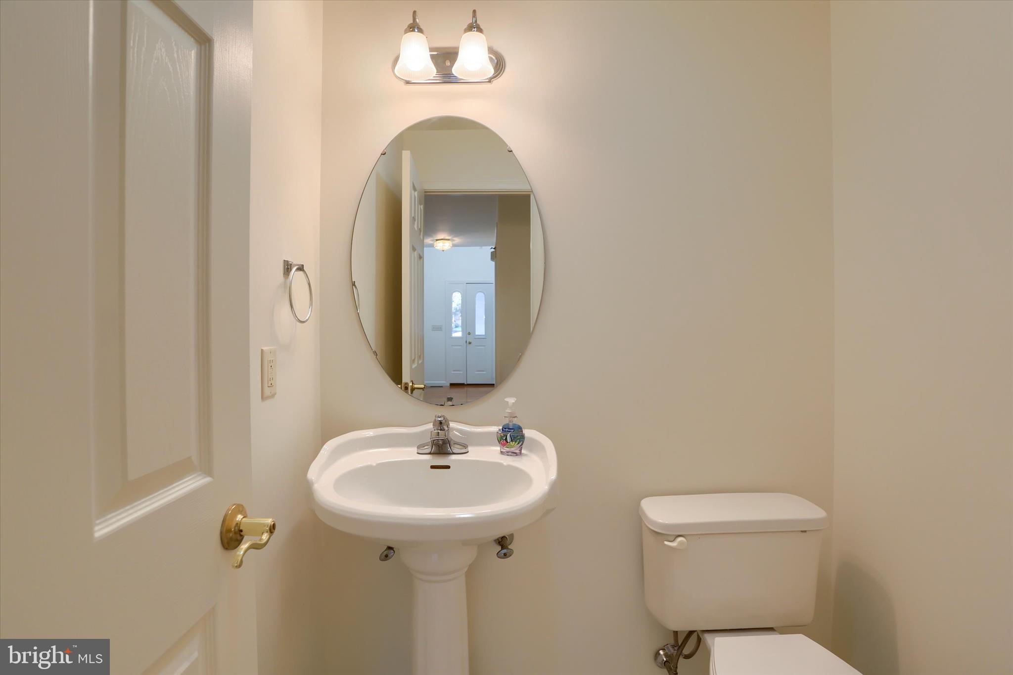 221 West Locust Street Enola, PA 17025 - Photo 10 of 46 a bathroom with a toilet sink and mirror