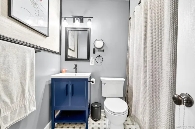 a bathroom with a toilet a sink and a mirror