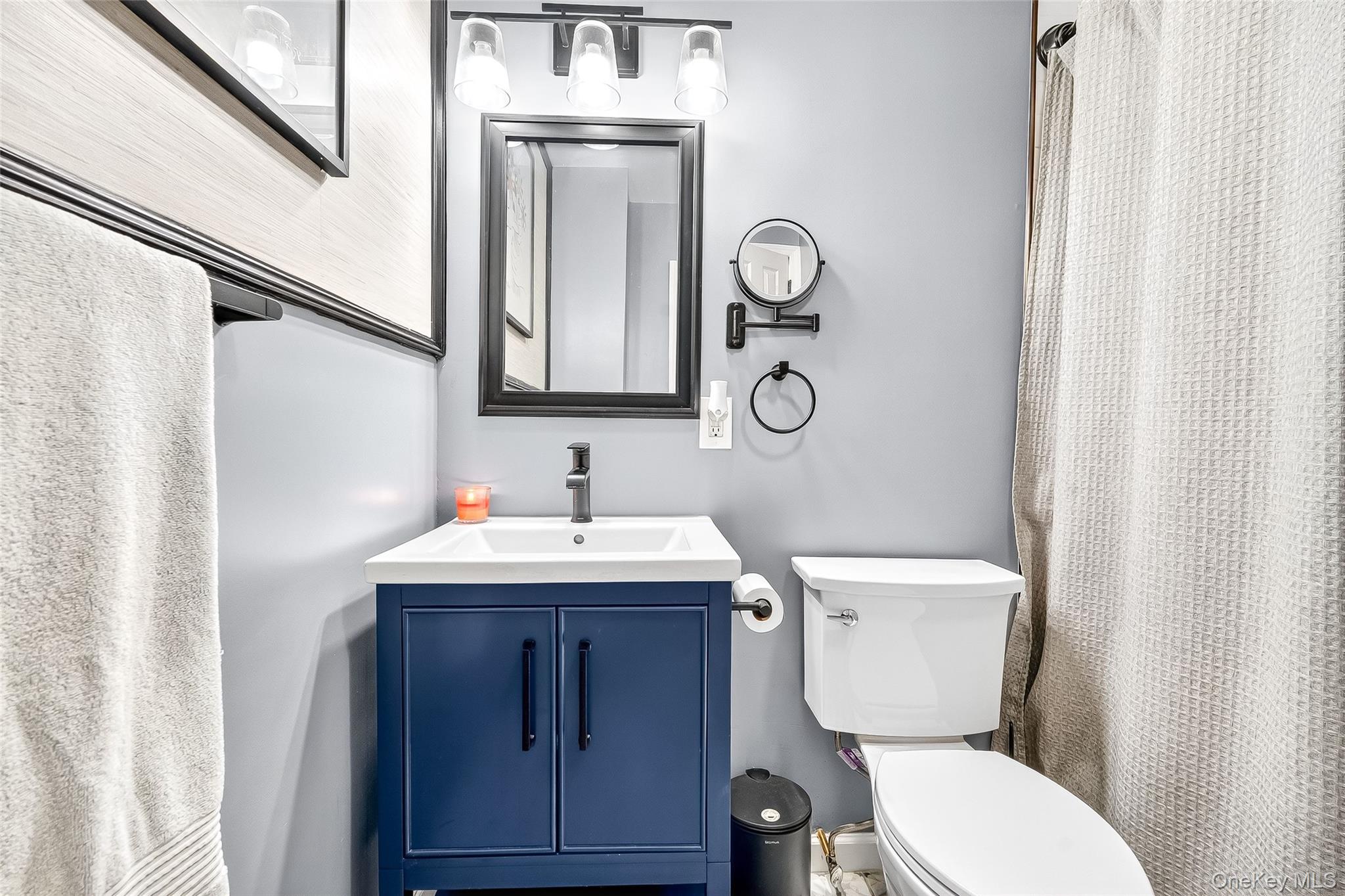 512 High Street Monroe, NY 10950 - Photo 13 of 18 a bathroom with a toilet a sink and mirror