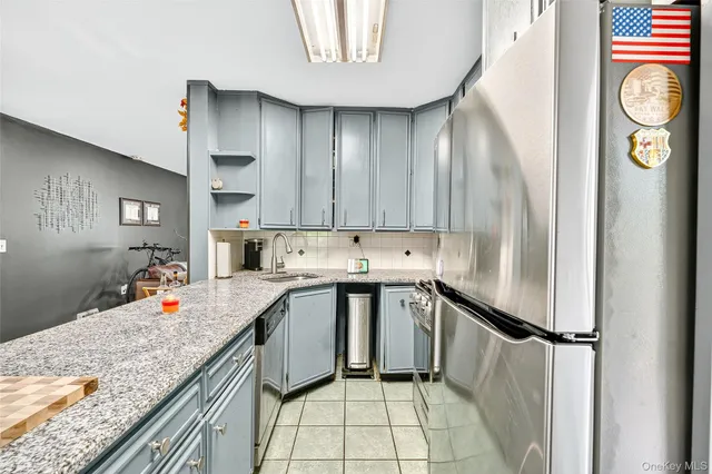 a kitchen with stainless steel appliances granite countertop refrigerator sink and cabinets