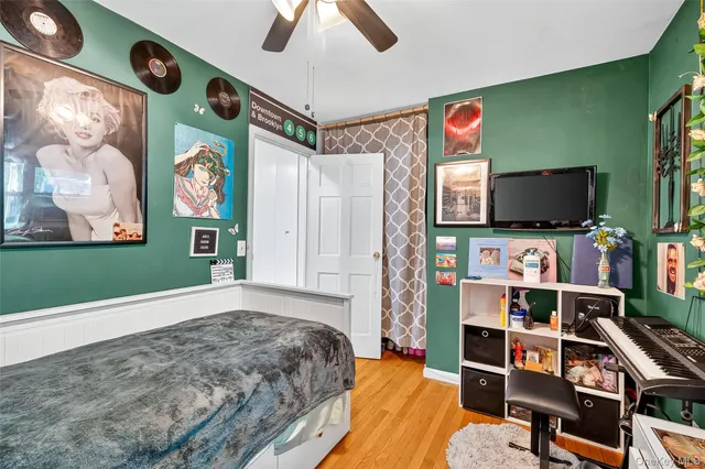 a bedroom with furniture and a flat screen tv