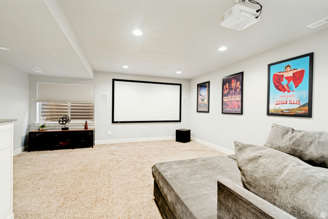 983 West 1550th Street South Springville, UT 84663 - Photo 39 of 43 Dedicated media room featuring a large projection screen, mounted projector, recessed lighting, and neutral carpeting.