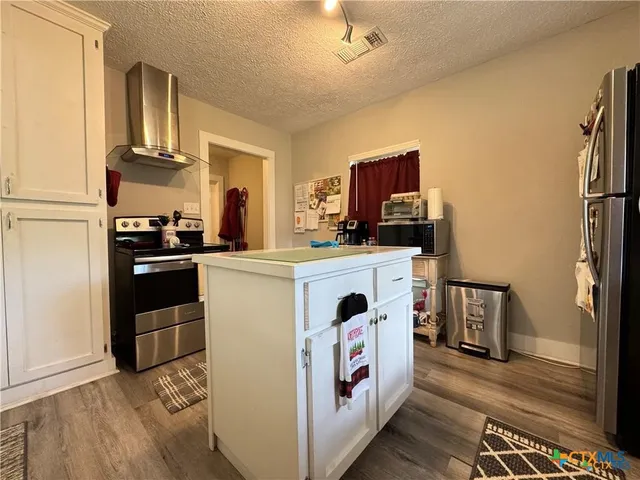 a kitchen with a sink stove and refrigerator