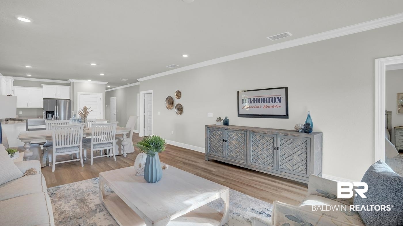 13312 Shea Circle Foley, AL 36535 - Photo 11 of 17 Spacious open-concept living area featuring wood-finish flooring, recessed lighting, and crown molding