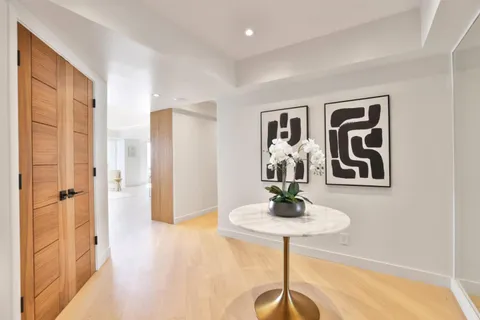 a kitchen with stainless steel appliances kitchen island granite countertop a refrigerator and cabinets