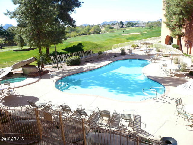 4303 East Cactus Road, Unit 116 Phoenix, AZ 85032 - Photo 31 of 35 a view of a swimming pool and a yard