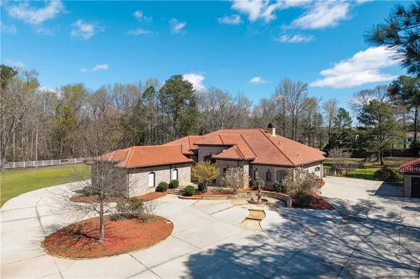 an aerial view of a house with a yard
