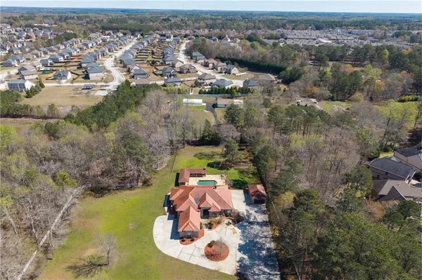an aerial view of a house with a swimming pool
