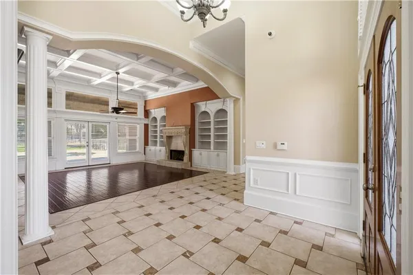 a large white kitchen with granite countertop a sink and cabinets