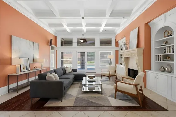 a living room with furniture fireplace and a large window