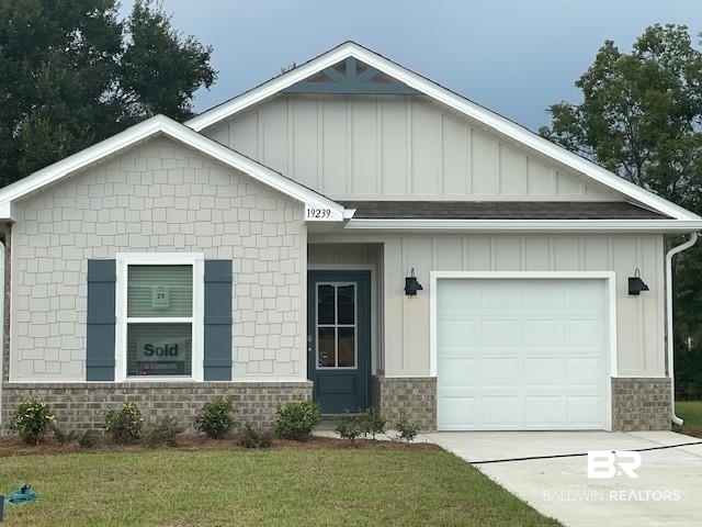 19239 Treehill Lane Summerdale, AL 36580 - Photo 1 of 1 View of front facade with a garage and a front lawn
