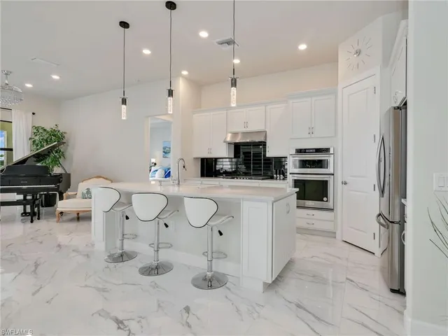 a living room with furniture and a piano