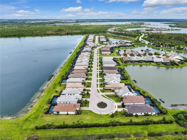 an aerial view of a house with a garden and lake view