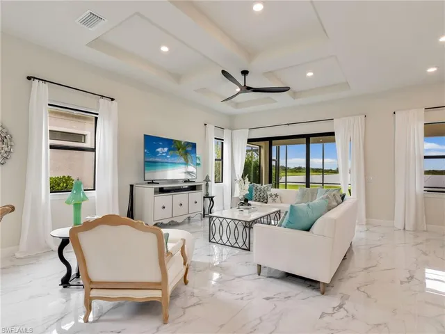 a view of a dining room with furniture and chandelier