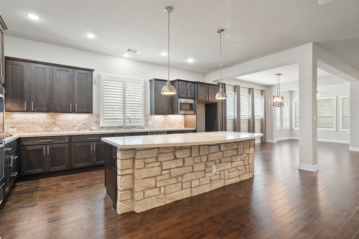 103 Lockhart Loop Georgetown, TX 78628 - Photo 11 of 40 a large kitchen with a table and chairs in it