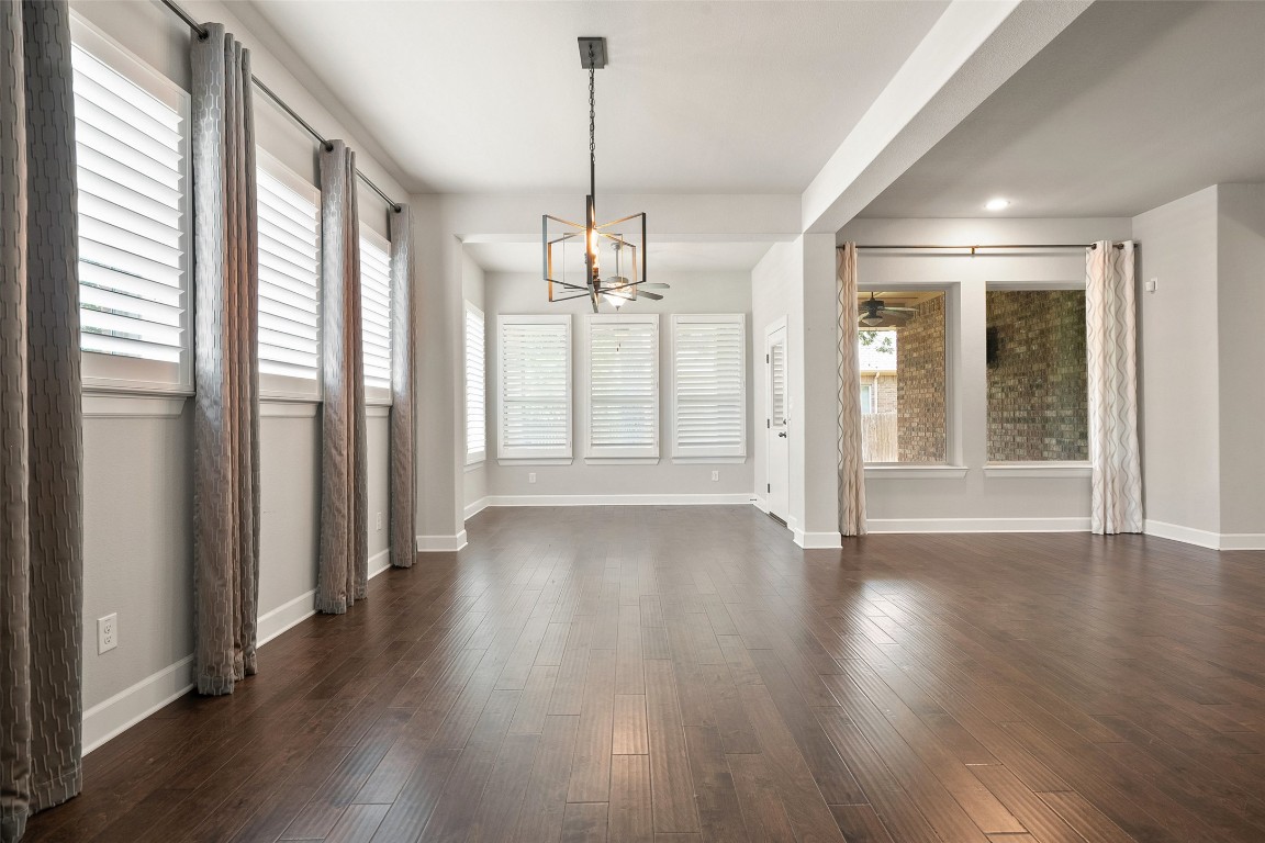103 Lockhart Loop Georgetown, TX 78628 - Photo 14 of 40 a view of an empty room with wooden floor and a window
