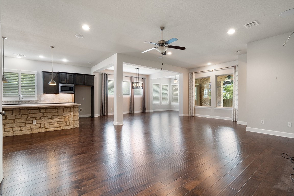 103 Lockhart Loop Georgetown, TX 78628 - Photo 21 of 40 an empty room with wooden floor and windows