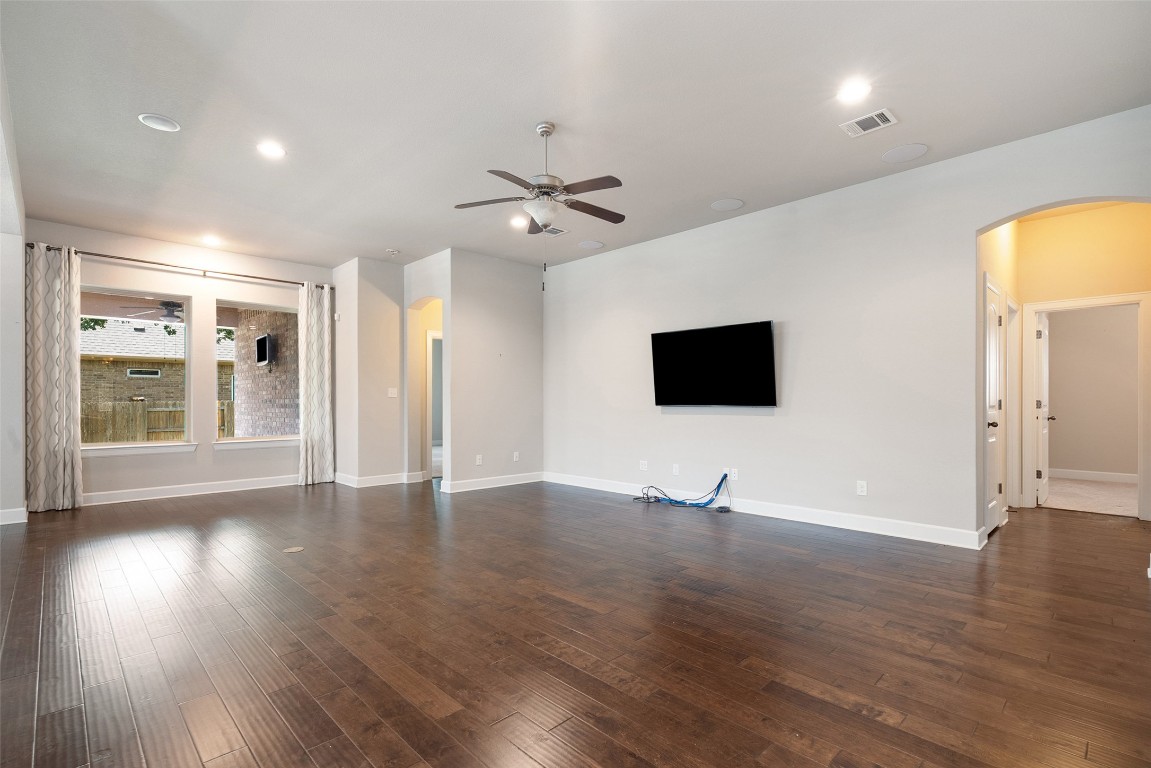 103 Lockhart Loop Georgetown, TX 78628 - Photo 22 of 40 a view of an empty room with wooden floor and a window