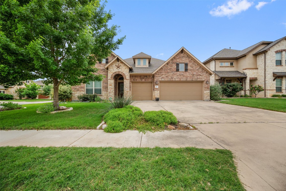 103 Lockhart Loop Georgetown, TX 78628 - Photo 3 of 40 a front view of a house with a yard and garage