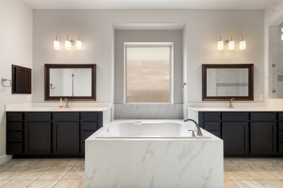 103 Lockhart Loop Georgetown, TX 78628 - Photo 30 of 40 a bathroom with a sink vanity and mirror