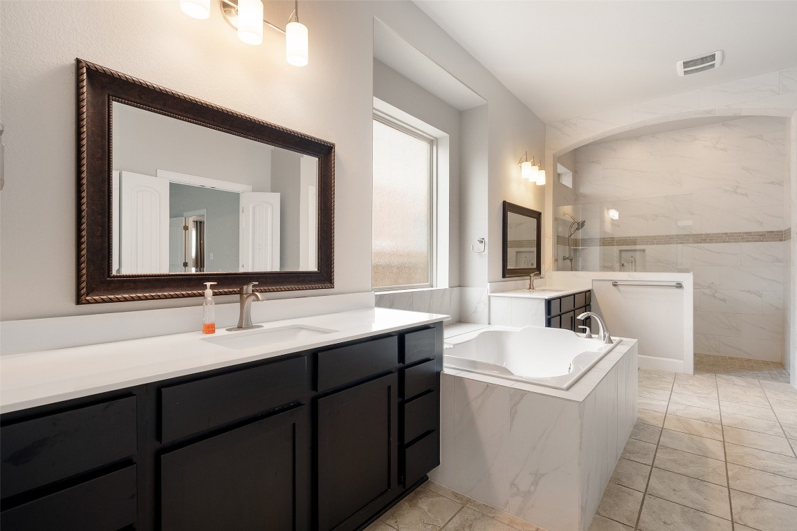 103 Lockhart Loop Georgetown, TX 78628 - Photo 31 of 40 a bathroom with a double vanity sink and mirror