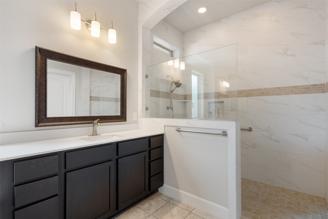 103 Lockhart Loop Georgetown, TX 78628 - Photo 34 of 40 a bathroom with a double vanity sink and mirror