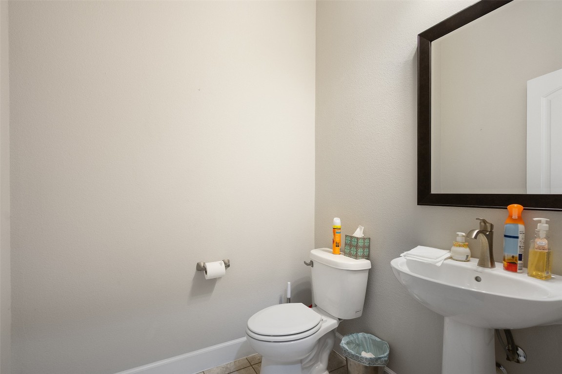 103 Lockhart Loop Georgetown, TX 78628 - Photo 35 of 40 a white toilet sitting next to a bathroom sink