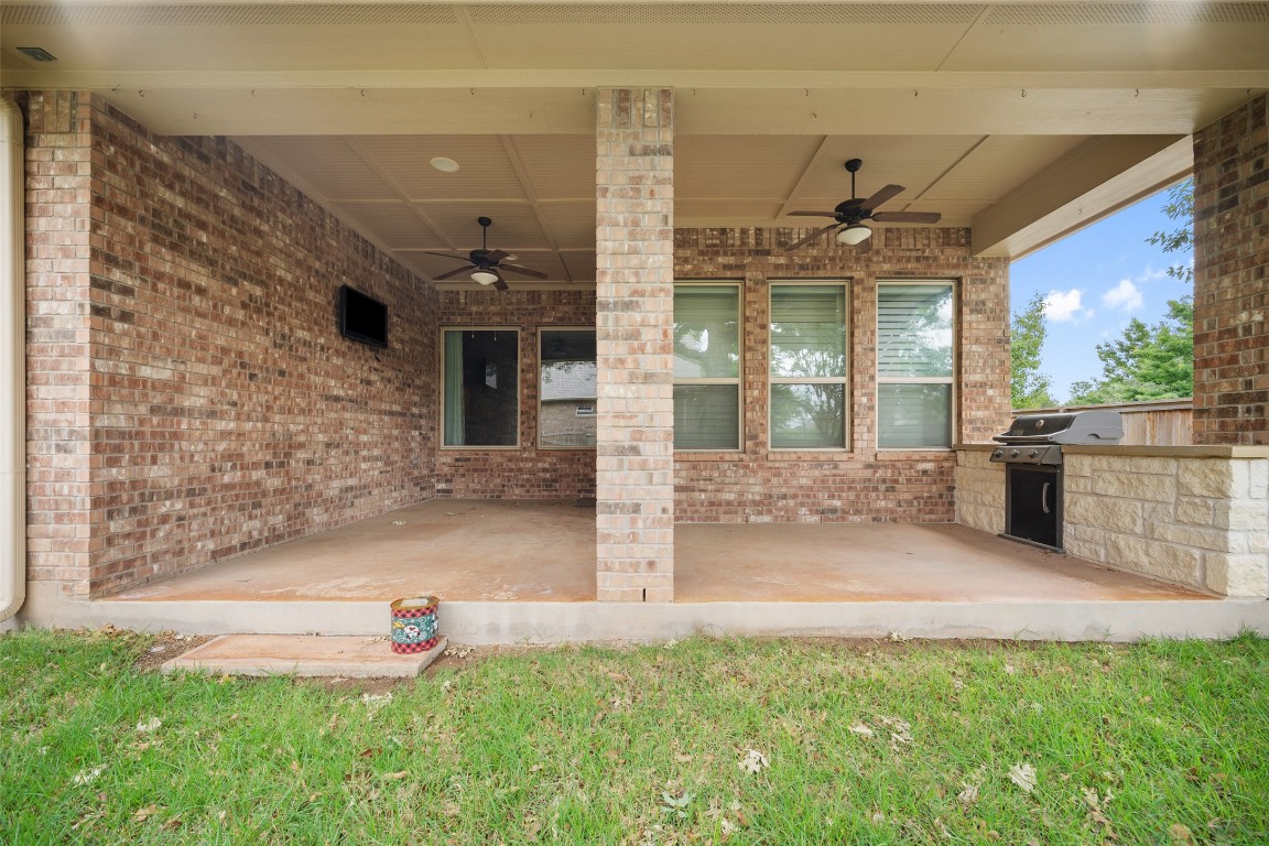 103 Lockhart Loop Georgetown, TX 78628 - Photo 37 of 40 View of patio / terrace featuring exterior kitchen, a ceiling fan, and a grill