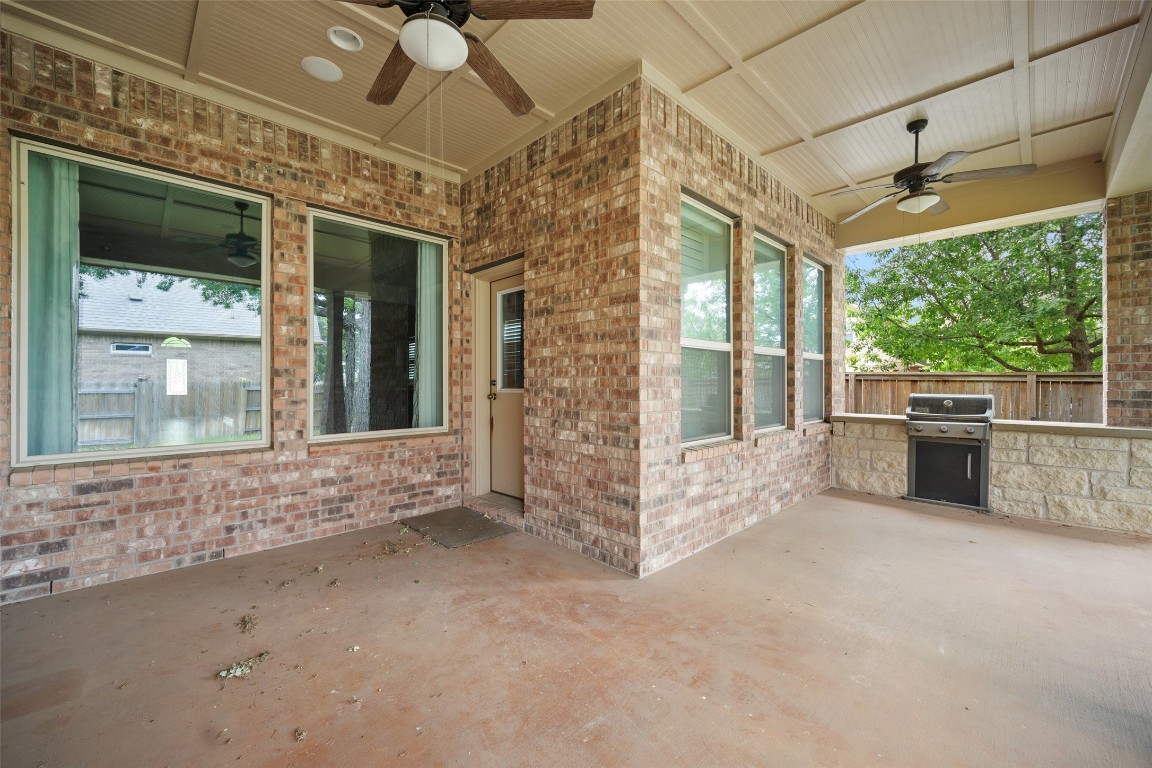 103 Lockhart Loop Georgetown, TX 78628 - Photo 38 of 40 View of patio with area for grilling, exterior kitchen, fence, and a ceiling fan