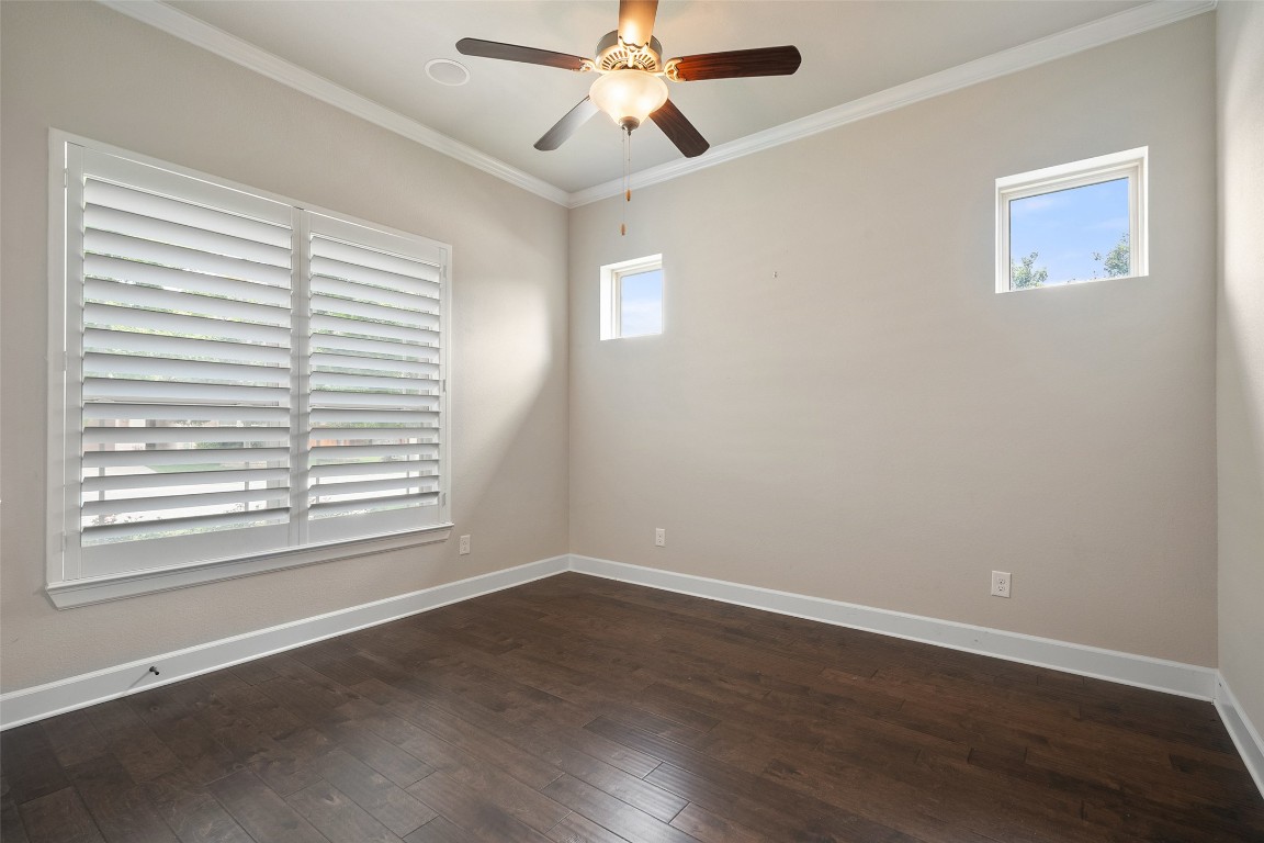 103 Lockhart Loop Georgetown, TX 78628 - Photo 8 of 40 a view of an empty room with wooden floor and a window