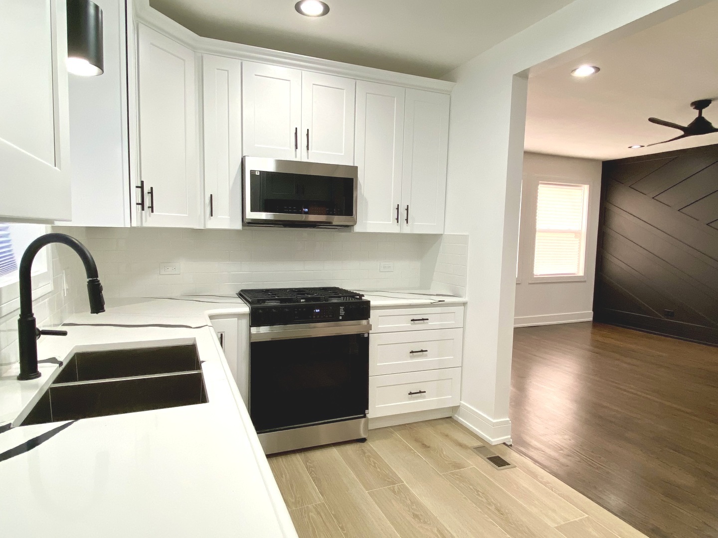 Undisclosed Address Chicago, IL 60619 - Photo 11 of 39 a kitchen with stainless steel appliances kitchen island granite countertop a stove a sink and a refrigerator