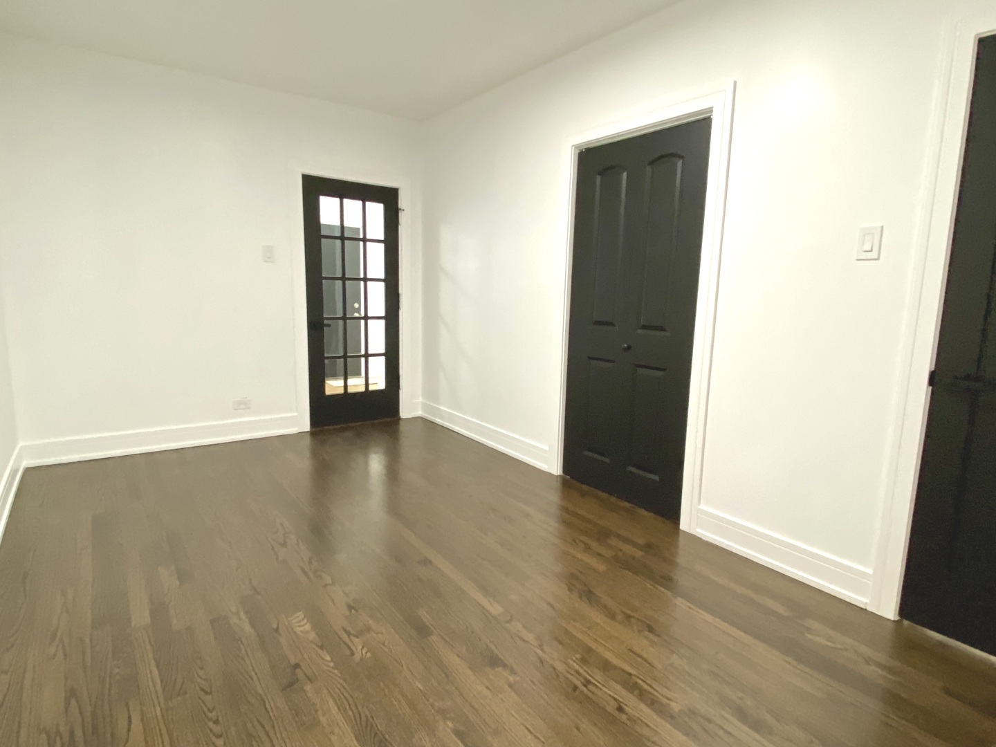 Undisclosed Address Chicago, IL 60619 - Photo 12 of 39 an empty room with wooden floor and windows