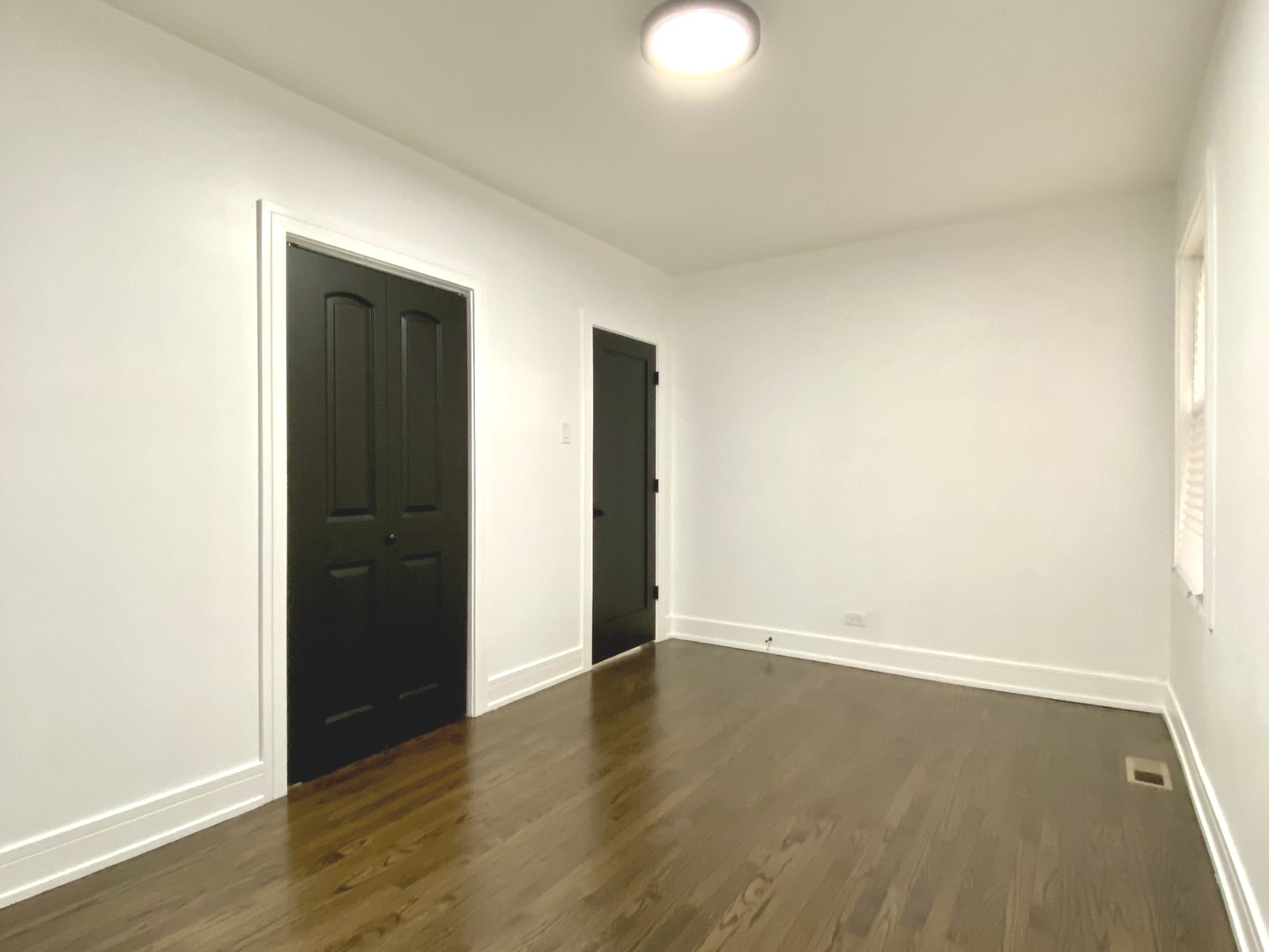 Undisclosed Address Chicago, IL 60619 - Photo 13 of 39 an empty room with wooden floor and closet