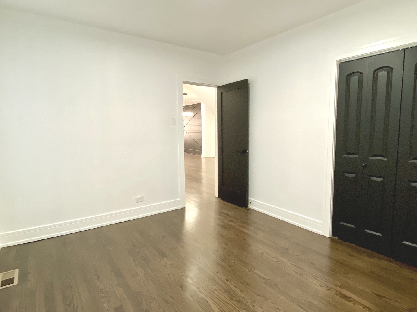 Undisclosed Address Chicago, IL 60619 - Photo 14 of 39 an empty room with wooden floor and closet