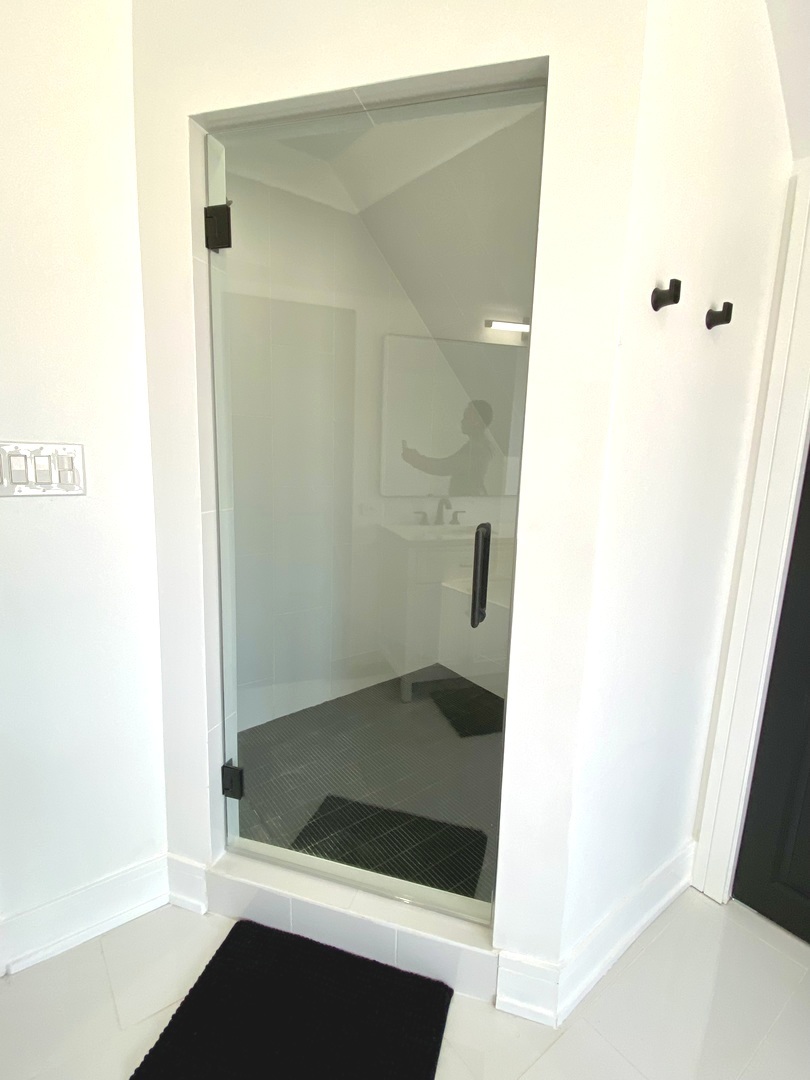 Undisclosed Address Chicago, IL 60619 - Photo 24 of 39 a bathroom with a glass shower door