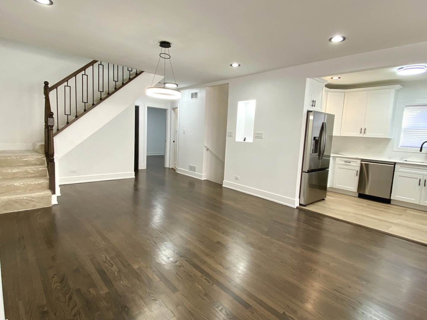 Undisclosed Address Chicago, IL 60619 - Photo 5 of 39 a view of a hallway with wooden floor and a kitchen