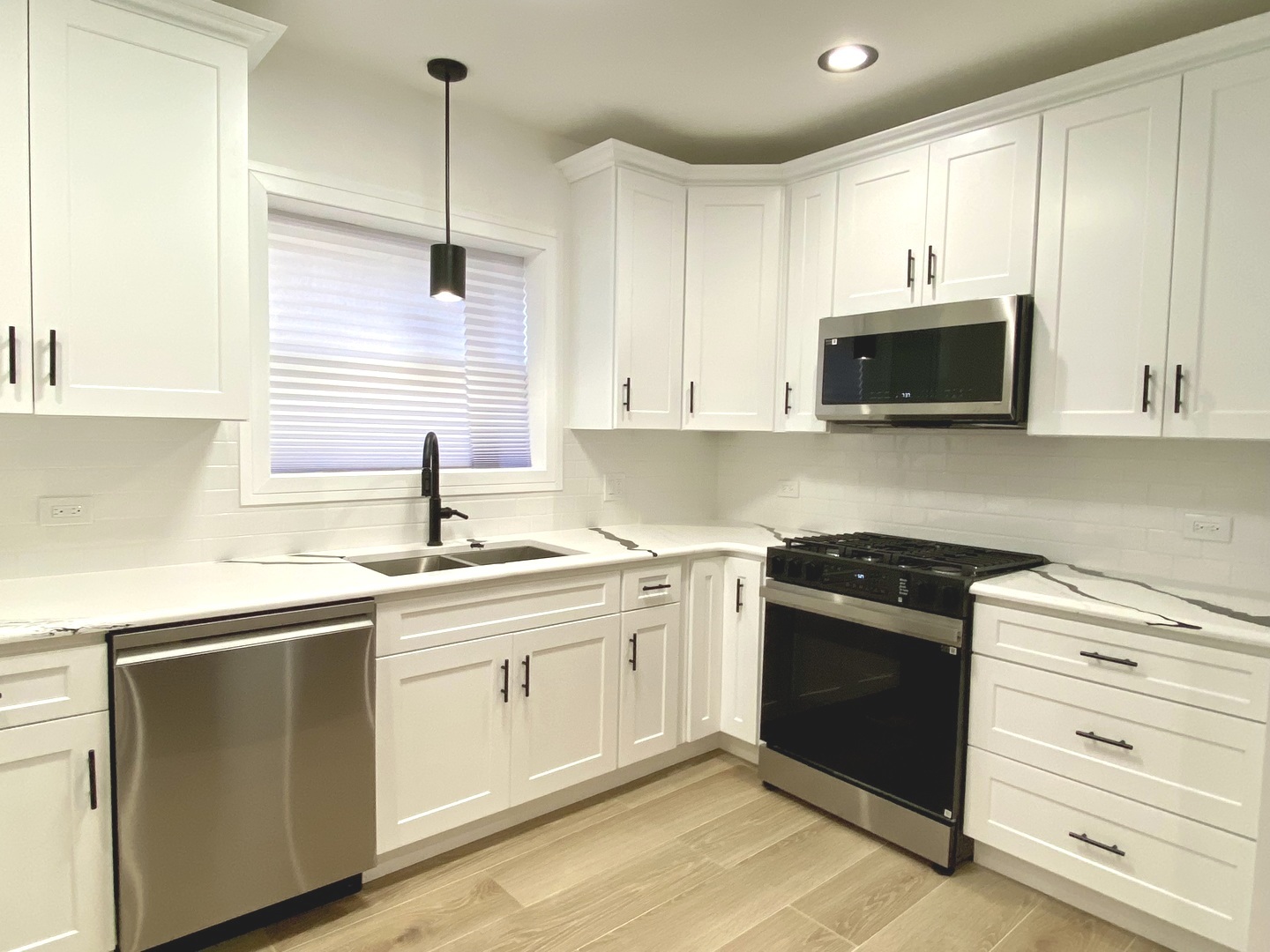 Undisclosed Address Chicago, IL 60619 - Photo 10 of 39 a kitchen with a sink stove and microwave