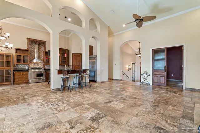 a kitchen view of a kitchen island sink stove and refrigerator