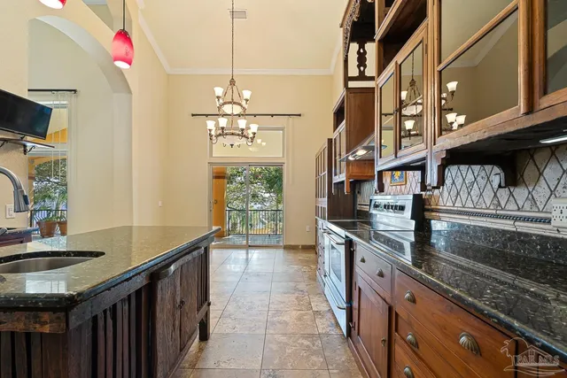 a view of kitchen with a refrigerator and a door