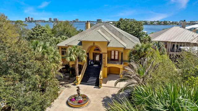 a living room with a fireplace and a potted plant