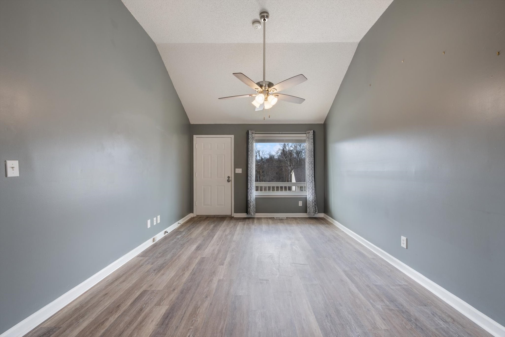 1007 Granny White Road Clarksville, TN 37040 - Photo 12 of 27 wooden floor in an empty room with a window