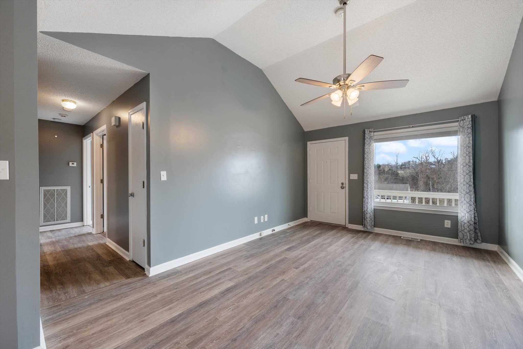 1007 Granny White Road Clarksville, TN 37040 - Photo 14 of 27 a view of an empty room with a window and wooden floor