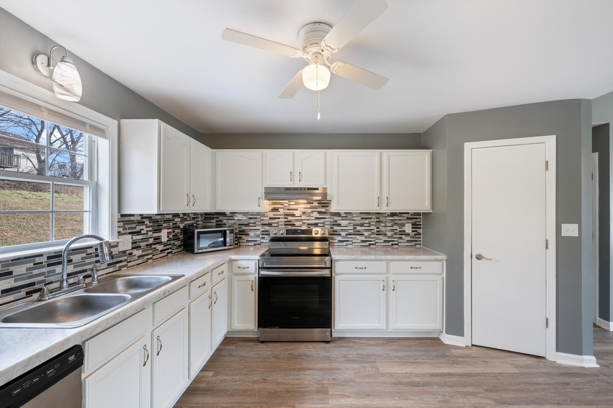 1007 Granny White Road Clarksville, TN 37040 - Photo 17 of 27 a kitchen with a sink stove and cabinets