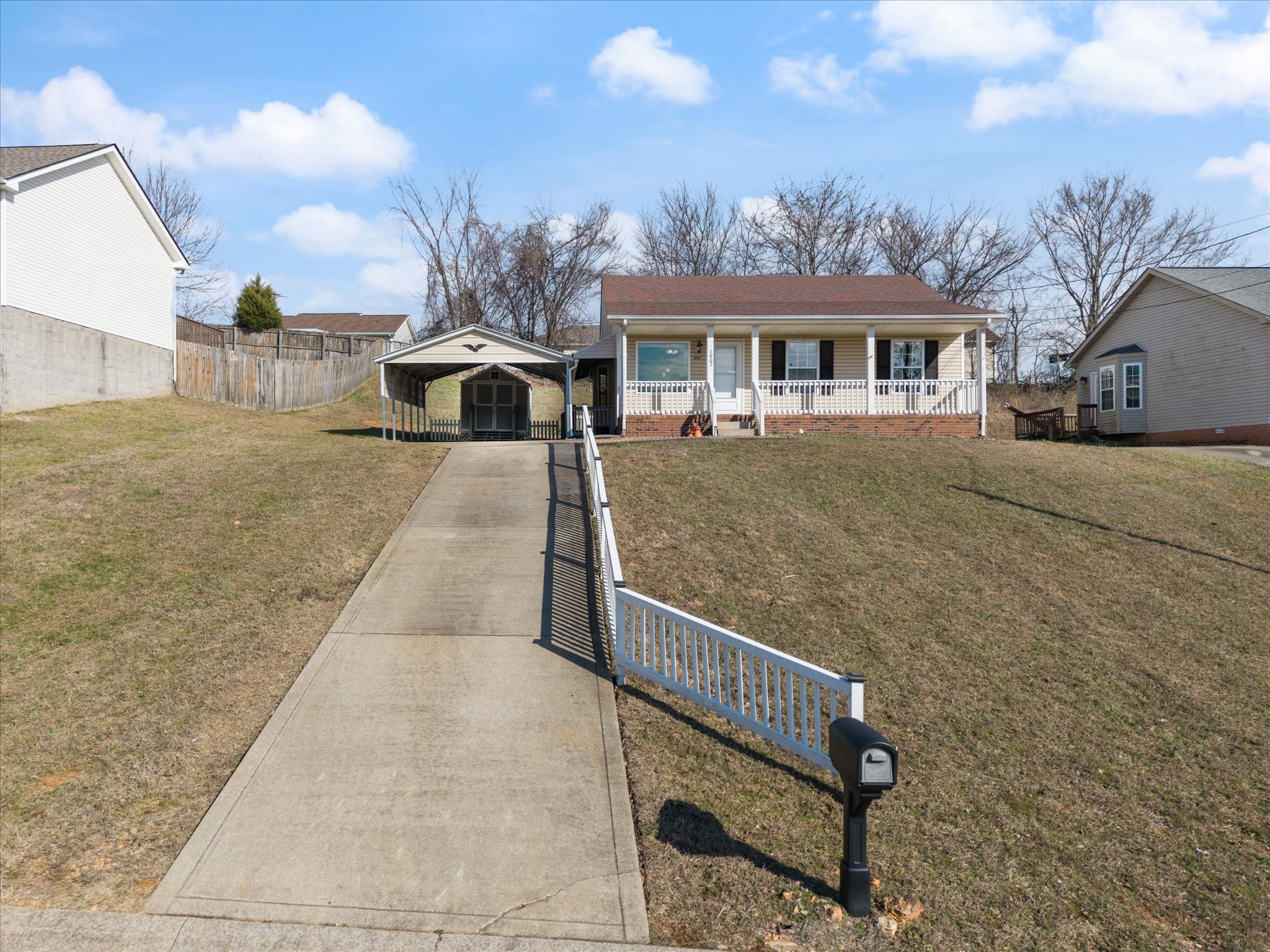 1007 Granny White Road Clarksville, TN 37040 - Photo 2 of 27 a front view of a house with yard garage and outdoor seating