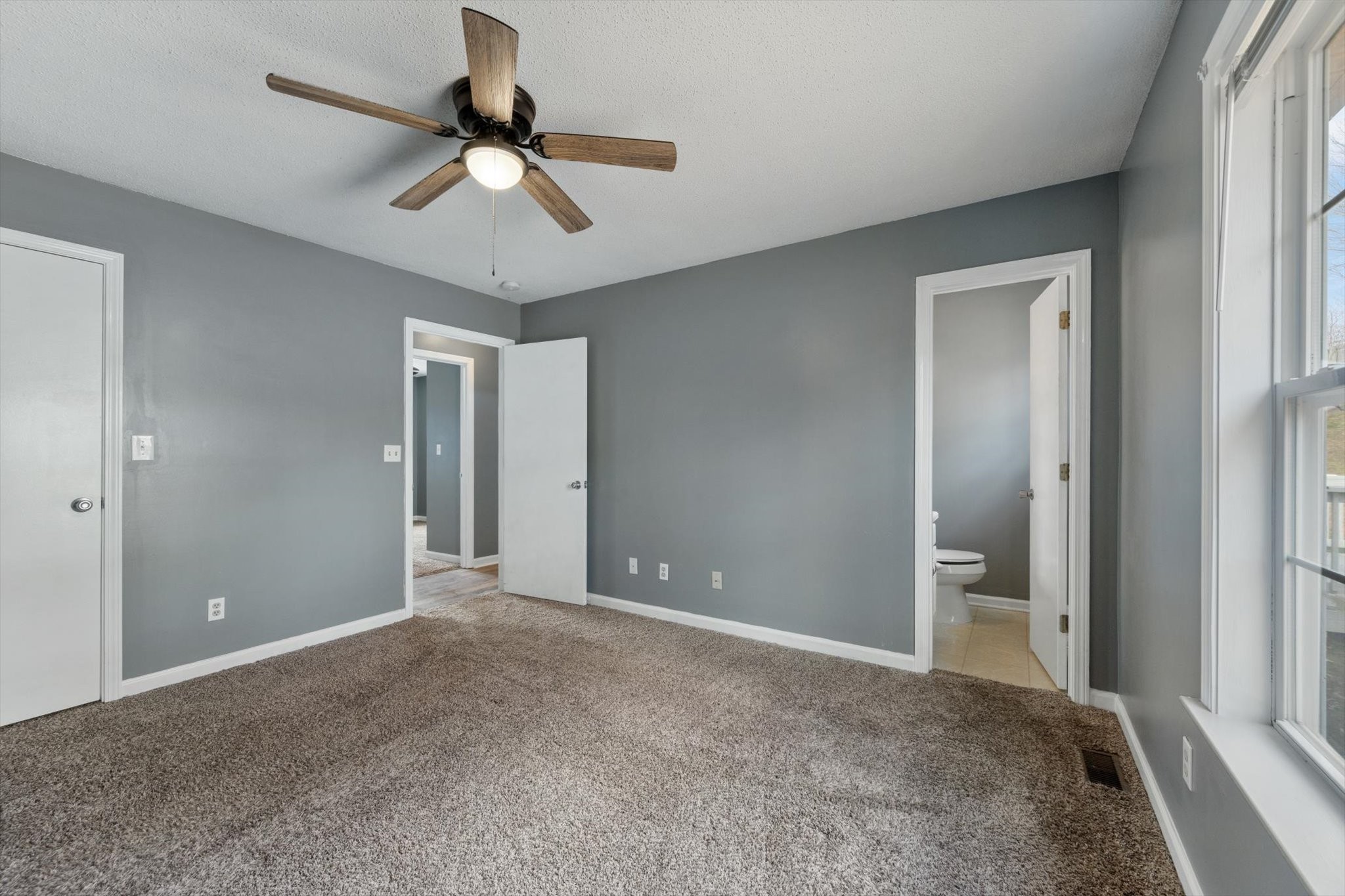 1007 Granny White Road Clarksville, TN 37040 - Photo 22 of 27 a view of an empty room and cabinet with a ceiling fan