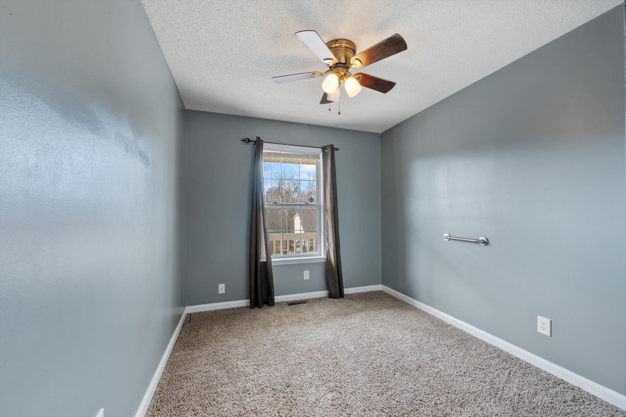 1007 Granny White Road Clarksville, TN 37040 - Photo 24 of 27 an empty room with windows and fan