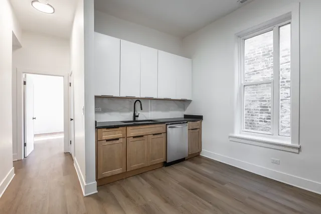 a kitchen with stainless steel appliances granite countertop a sink and a stove top oven